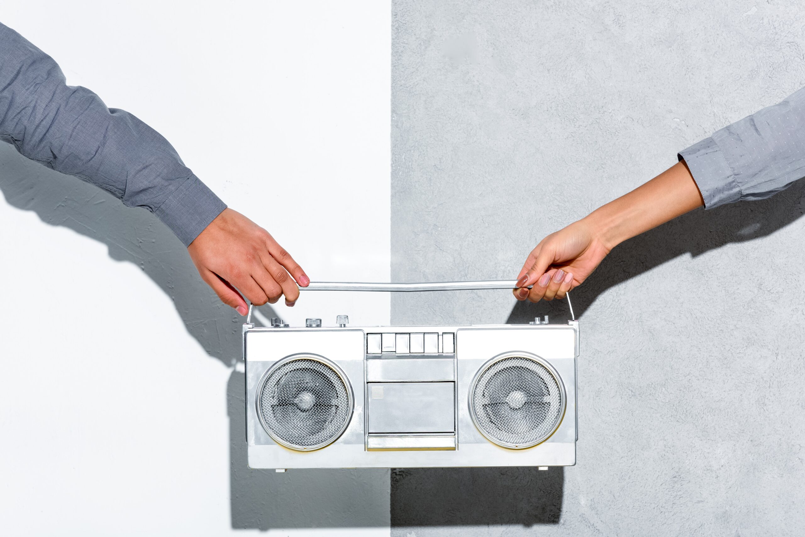 two hands holding a radio